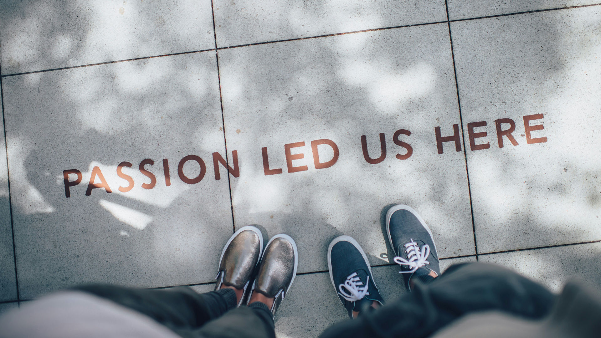 Two People Standing by Inspirational Sidewalk Message