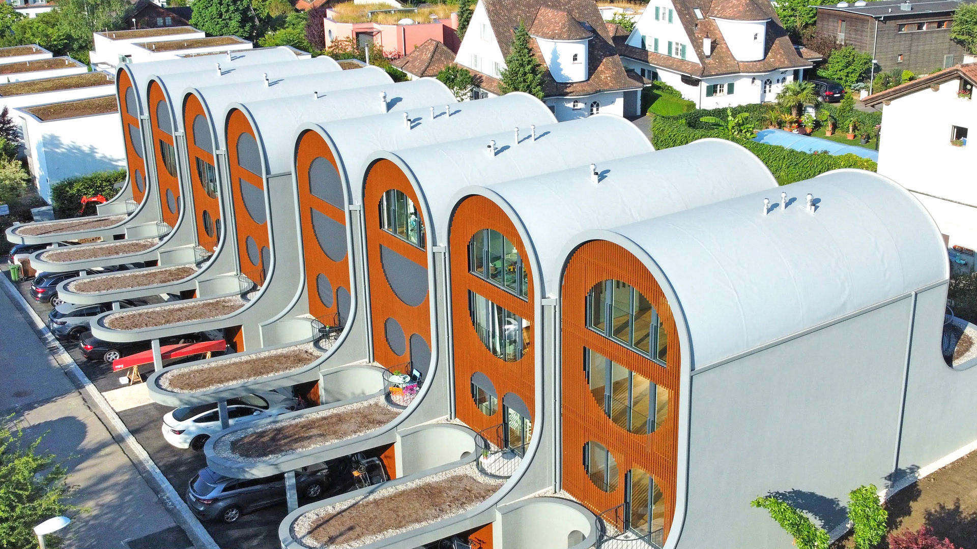 Cloudline townhouse units with curved roofs in Bottmingen, Switzerland using Sarnafil roof membrane