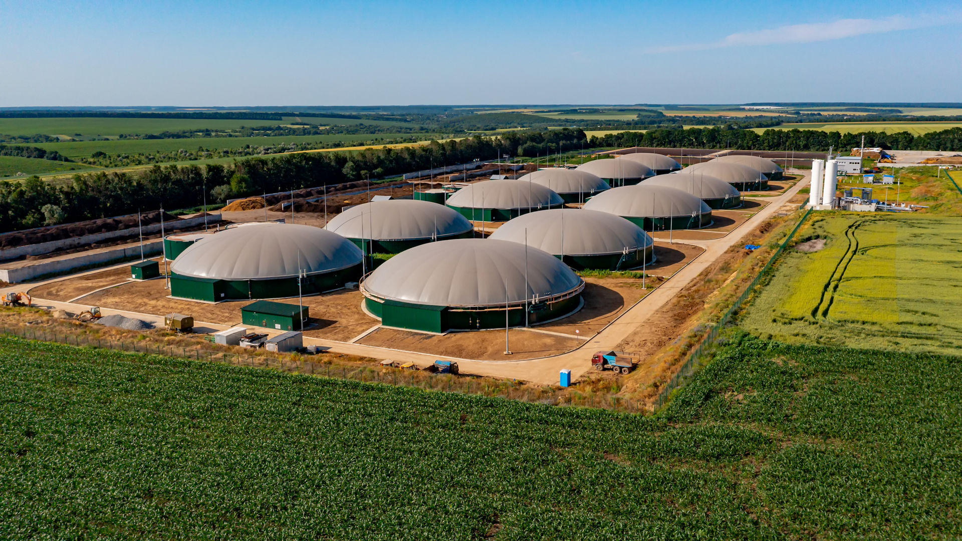 Twelve metal silos in a field