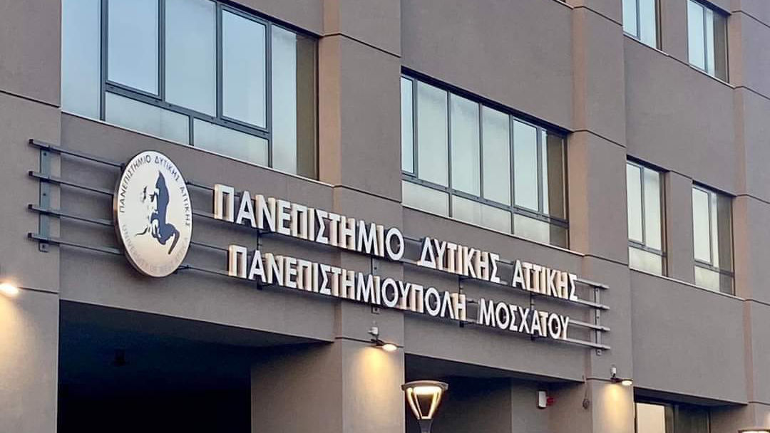 Modern University Building with Greek Signage at Sunset