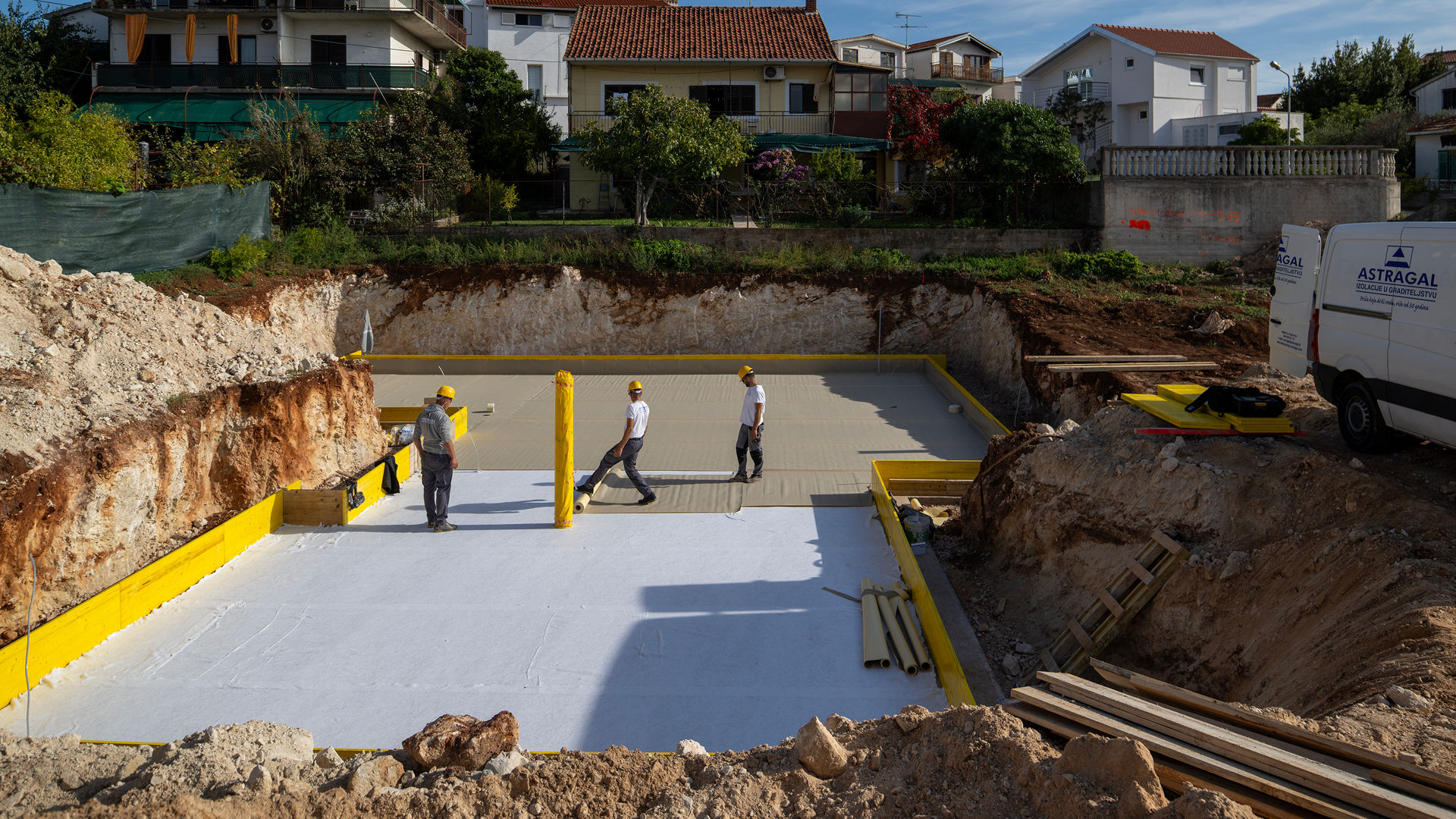 Construction workers preparing foundation site