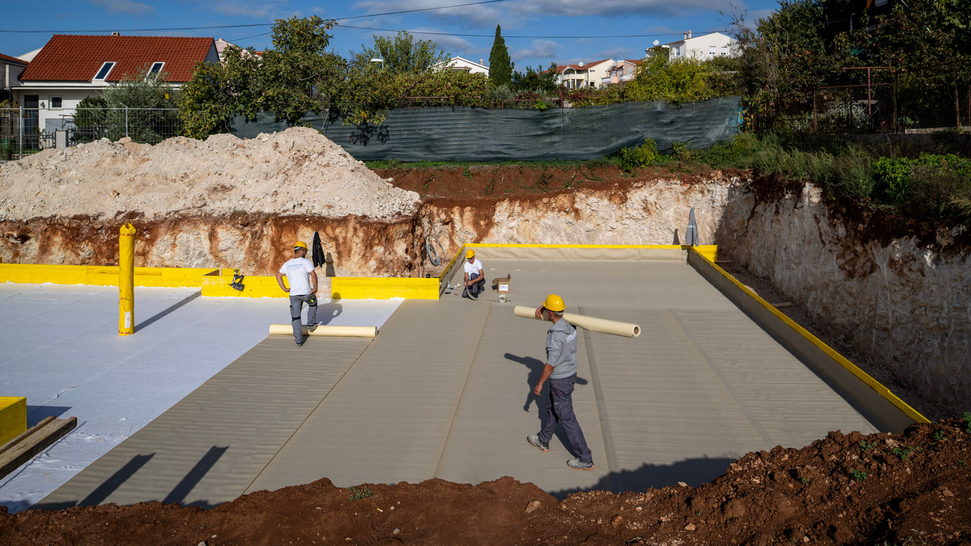 Construction workers preparing building foundation
