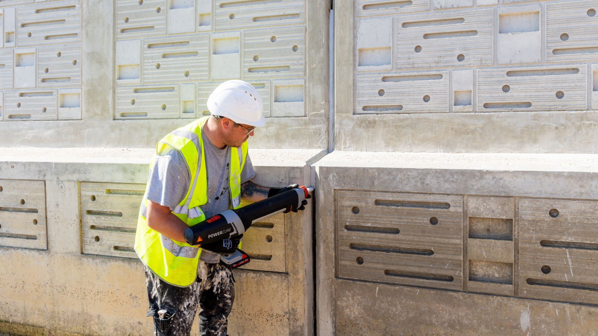 man applying sealant to wall joint