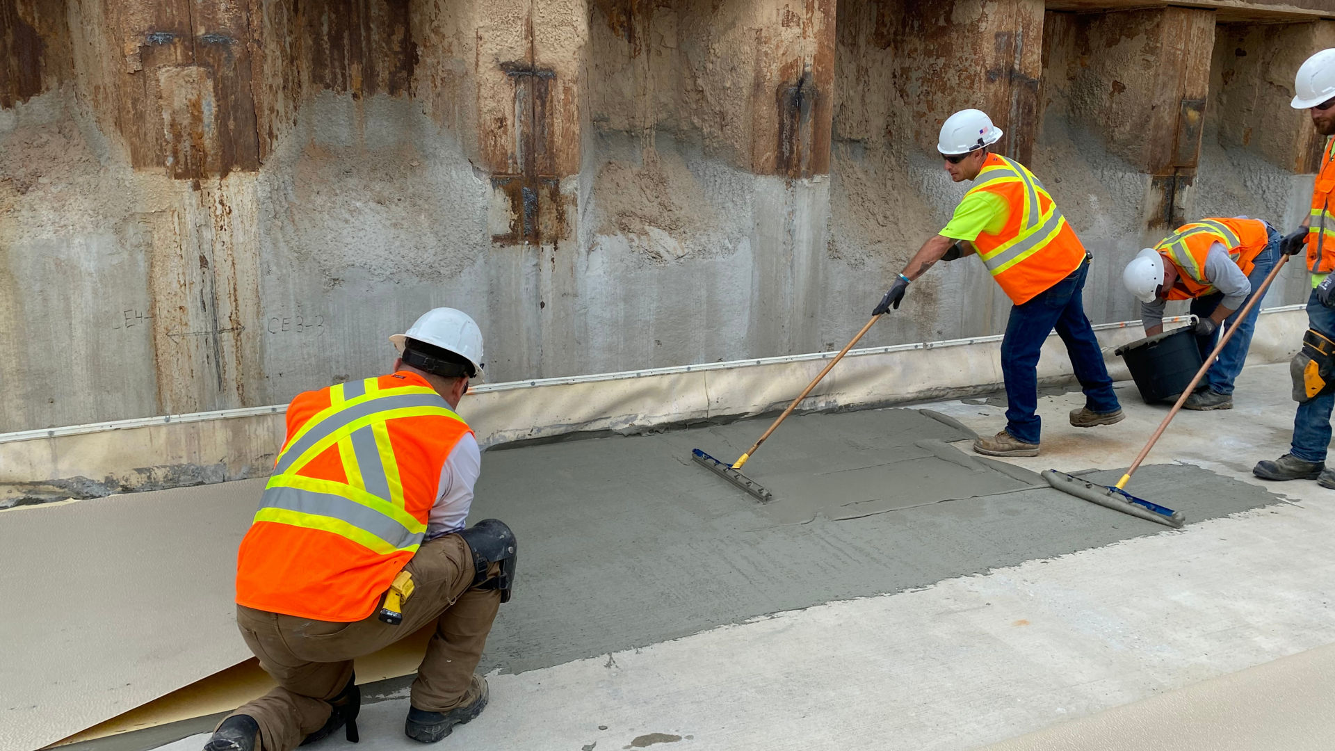 construction workers applying waterproofing membrane