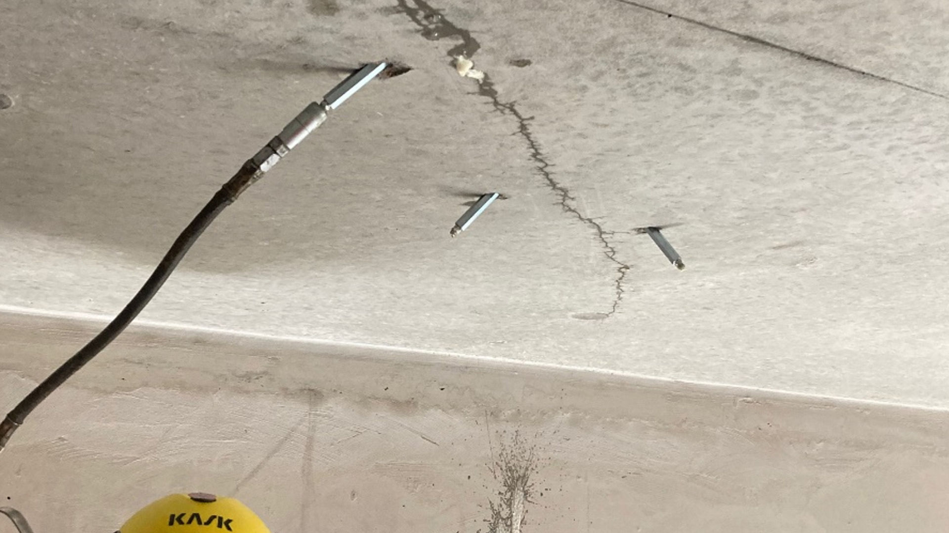 man applying waterproof injection to concrete