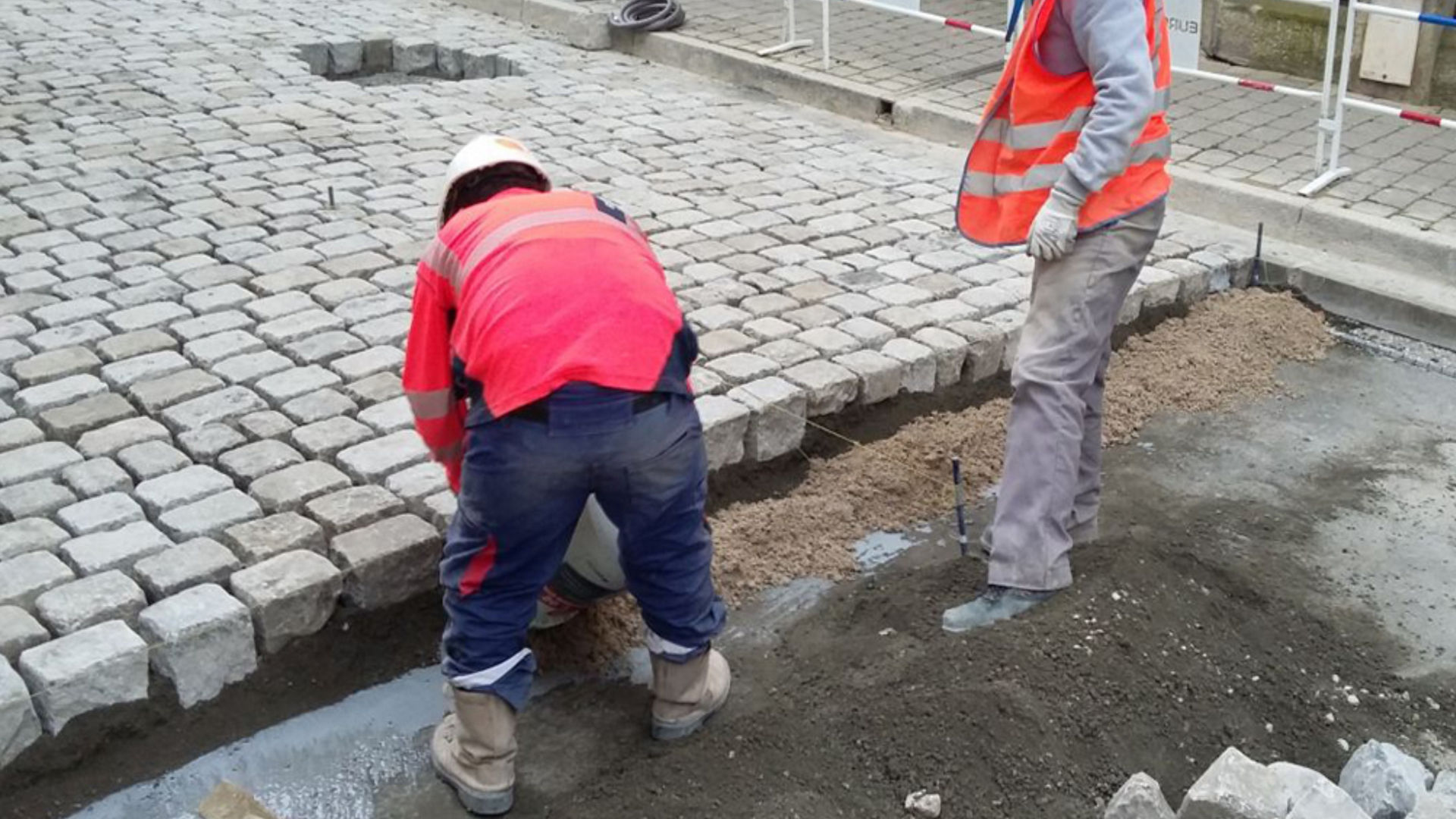 men laying paving stones 