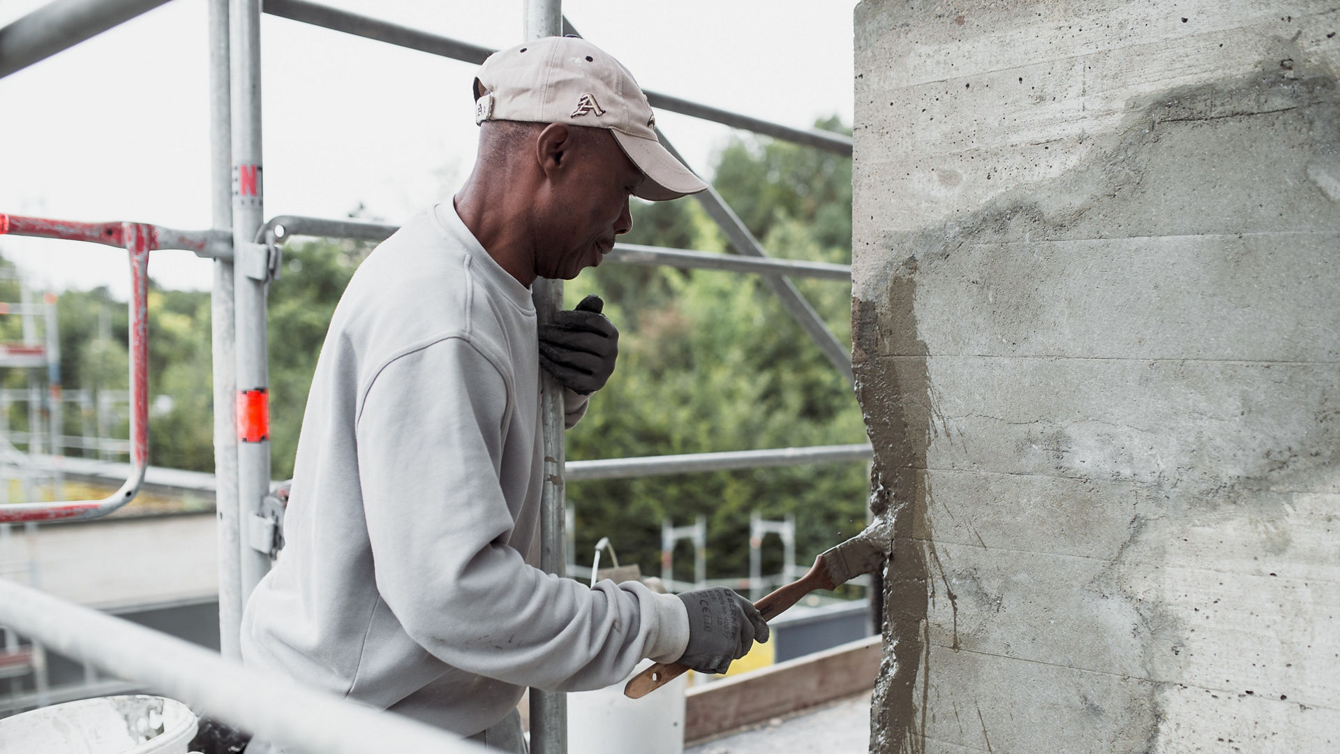 Construction worker repairing concrete wall