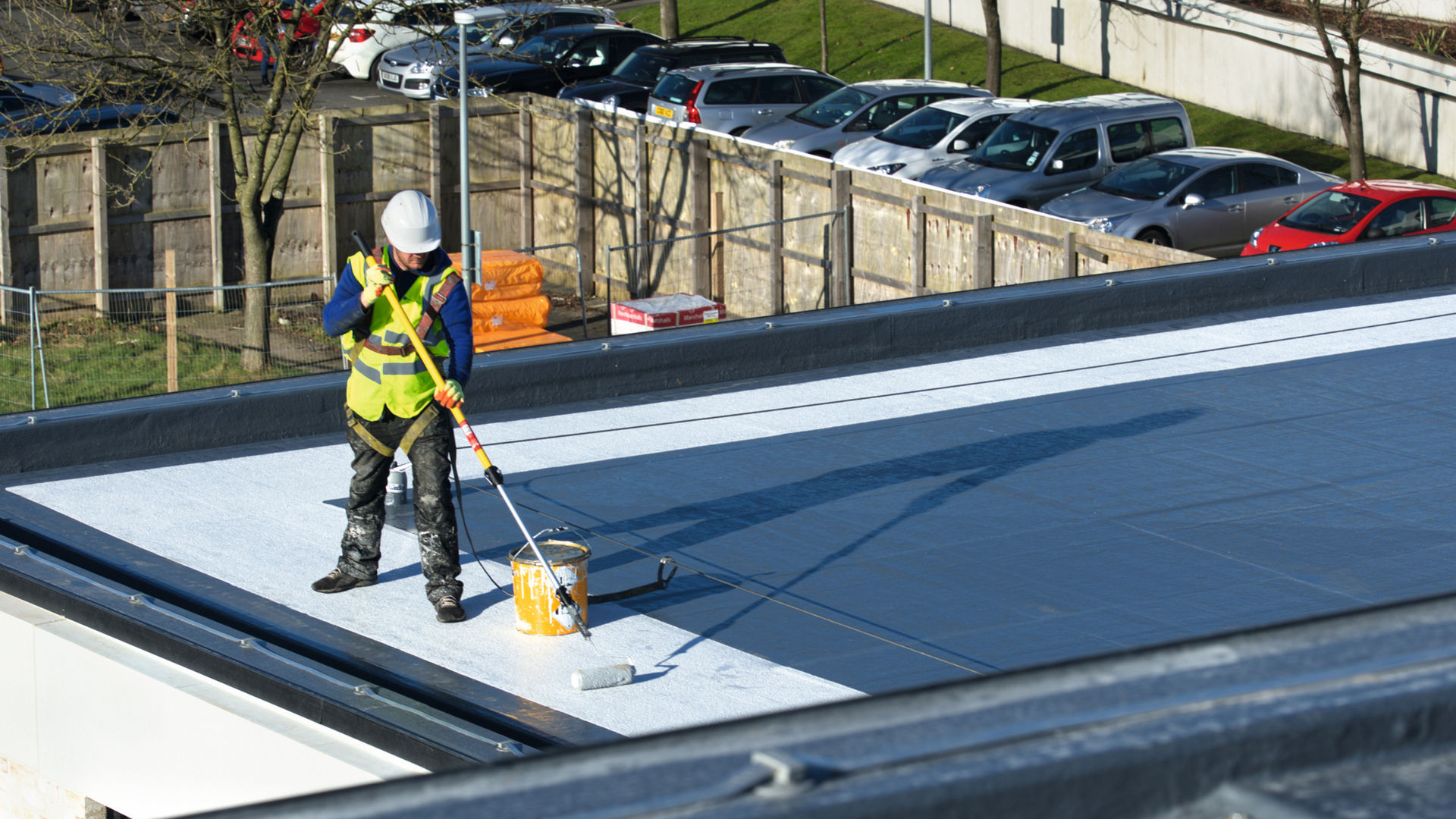 man applying liquid roofing membrane