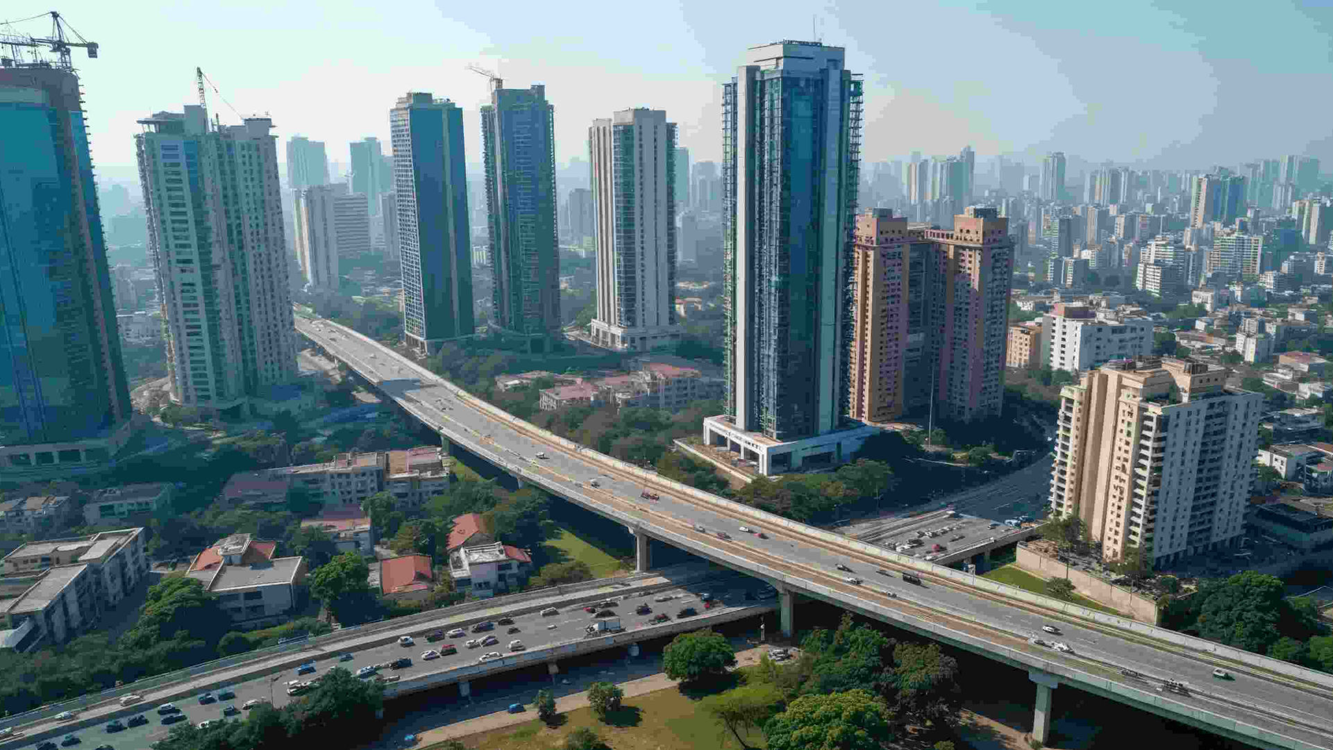Aerial view of urban infrastructure in India with high-rise buildings, elevated highways, and ongoing construction, showcasing modern city development and potential applications for Sika India’s construction chemicals and solutions