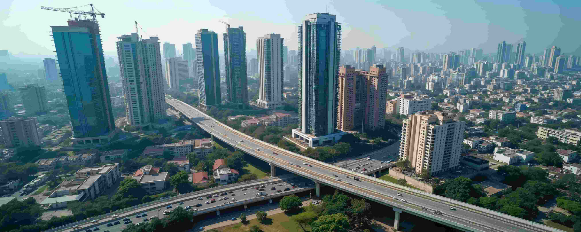 Aerial view of urban infrastructure in India with high-rise buildings, elevated highways, and ongoing construction, showcasing modern city development and potential applications for Sika India’s construction chemicals and solutions