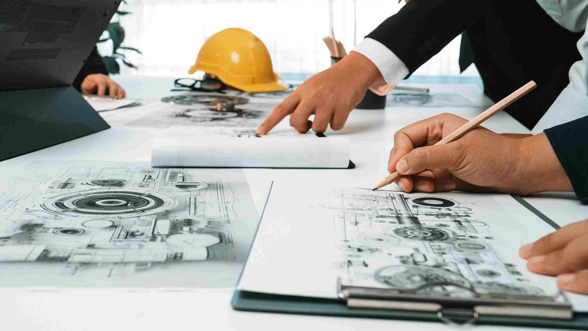 Engine design meeting with technical drawings