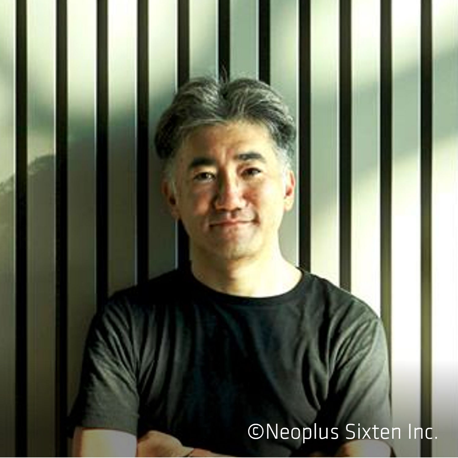 Man in black shirt against striped wall