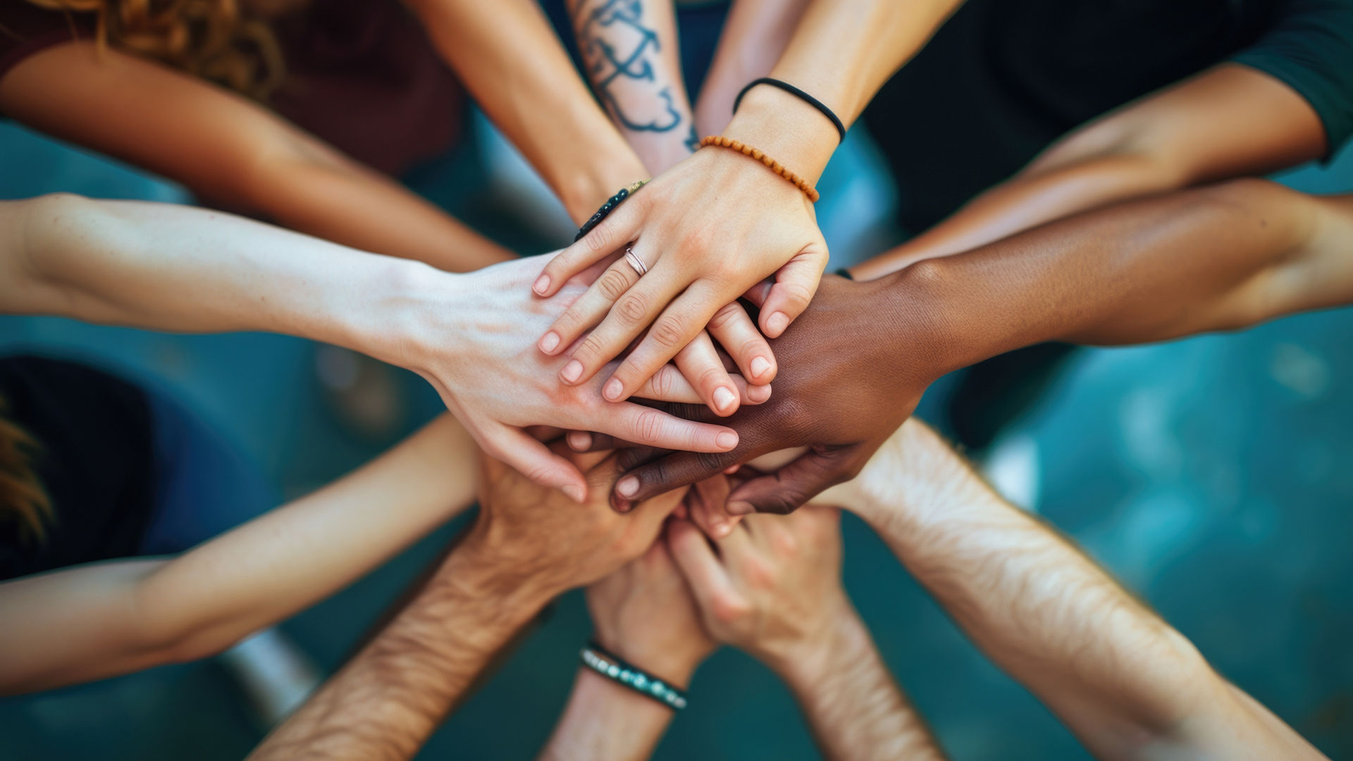 Diverse group joining hands in unity