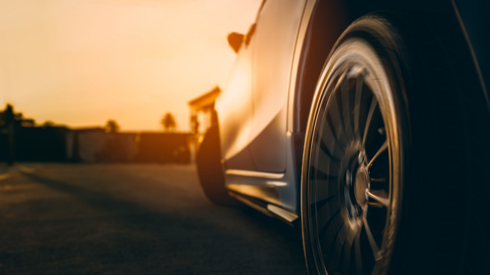 Close-up of car wheel in motion at sunset