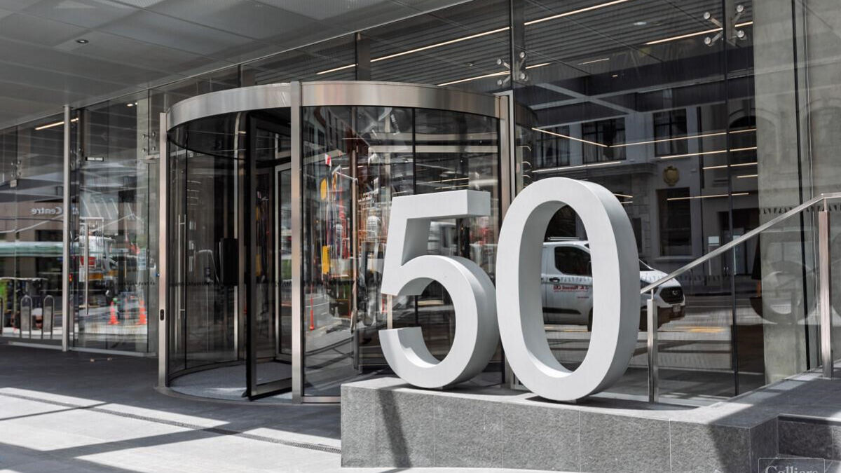 Modern building entrance with large 50 sign