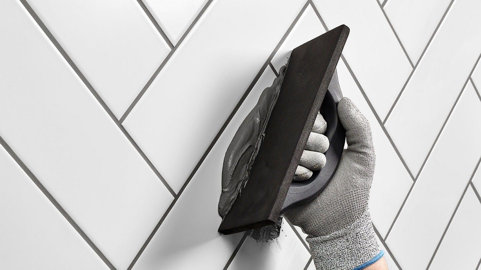 Grout being applied to wall tiles