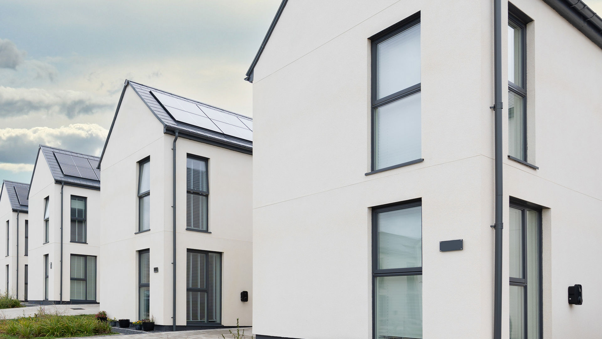Modern white houses with solar panels