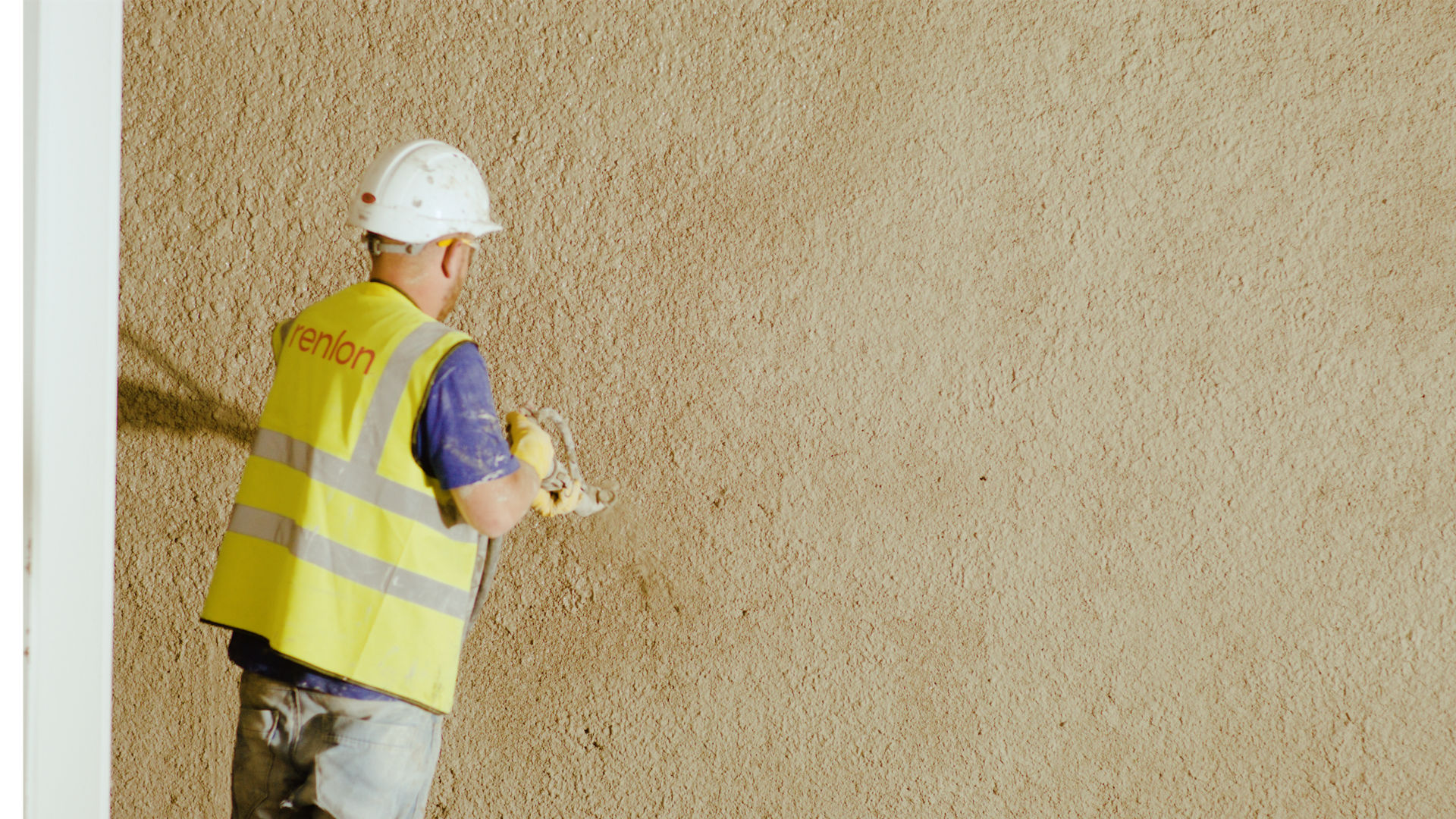 Construction worker applying wall plaster