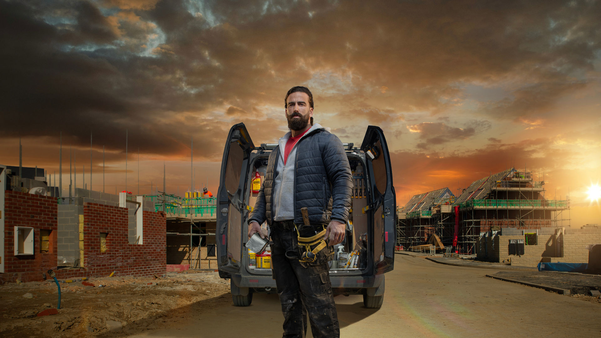 man stood in front of van on building site