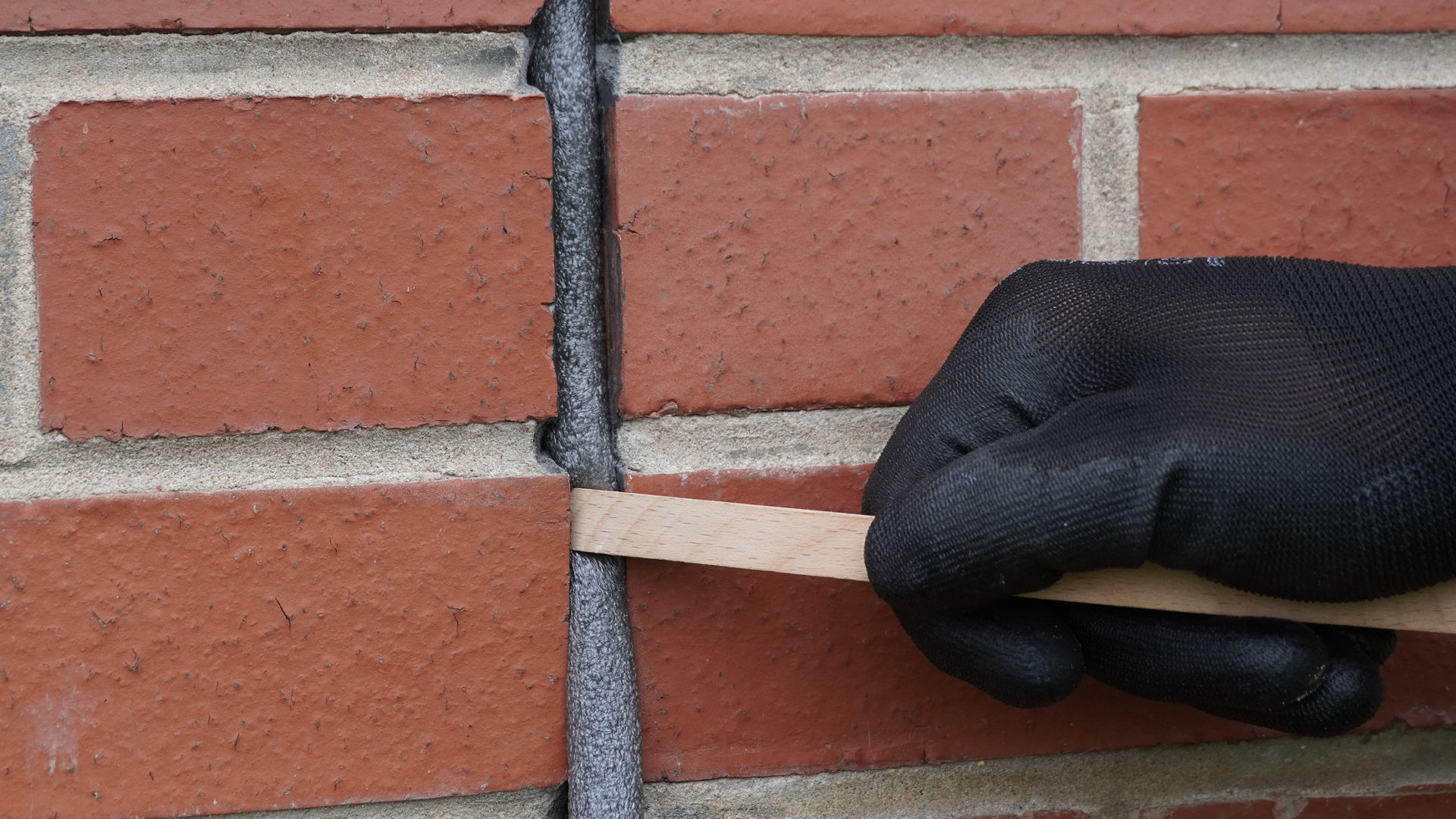 Person applying Sikaseal Joint Backer Rod