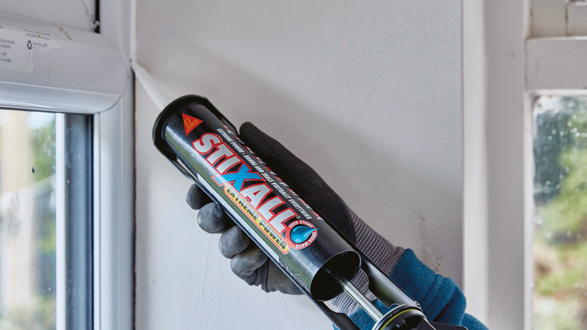 Person applying Stixall to window