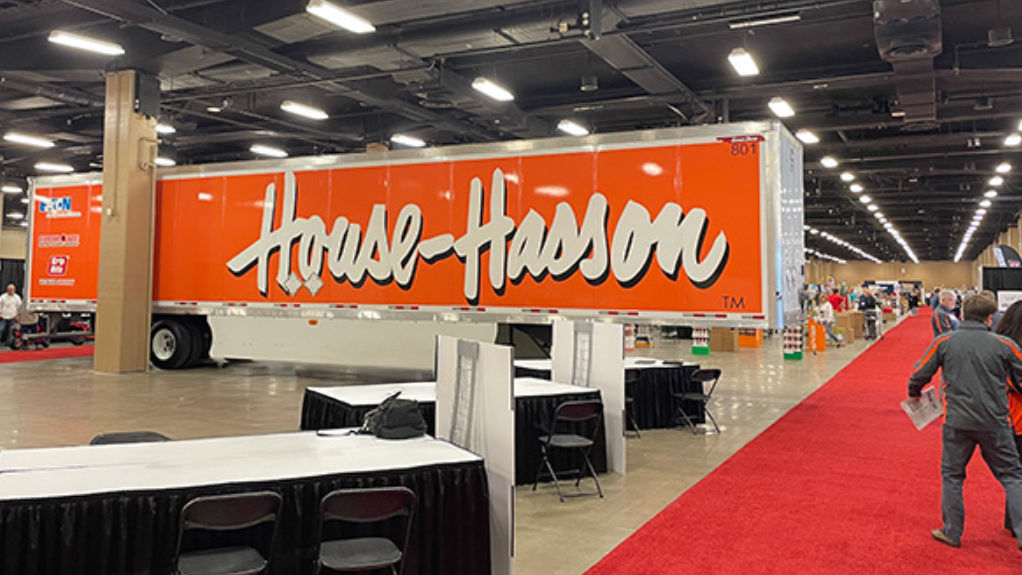 Large orange trailer at indoor trade show