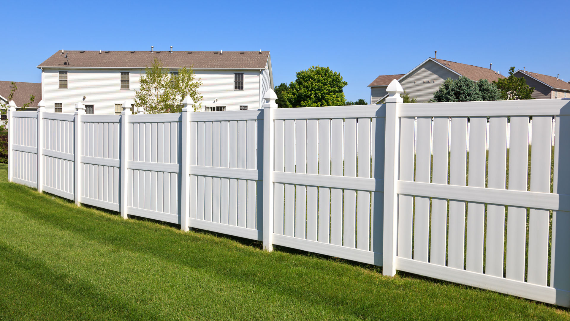 White vinyl fence in suburban neighborhood