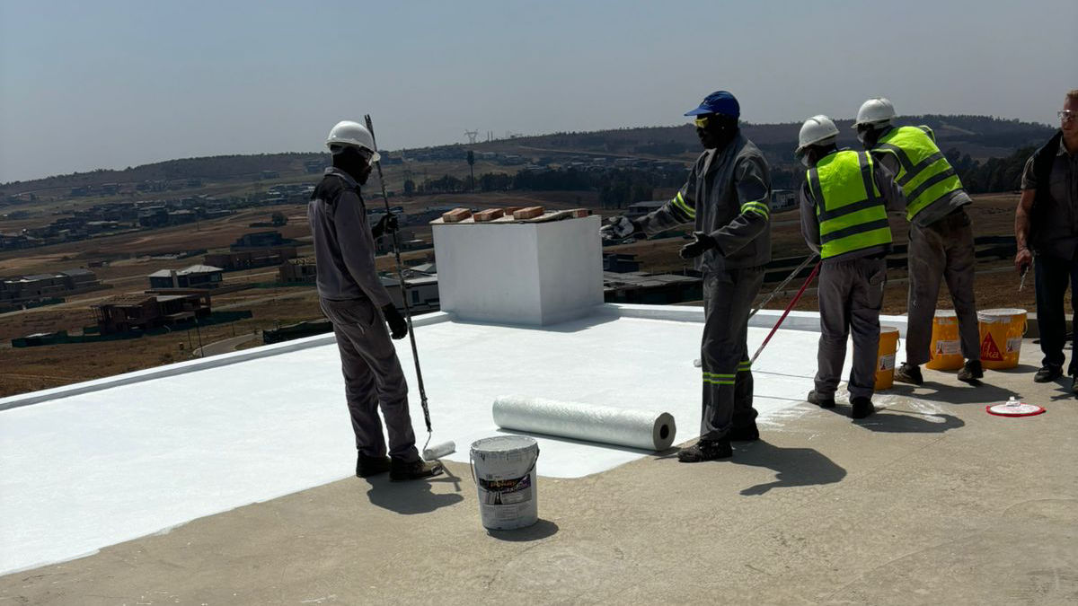 Application of reinforcing mat on first layer of LAM application.
