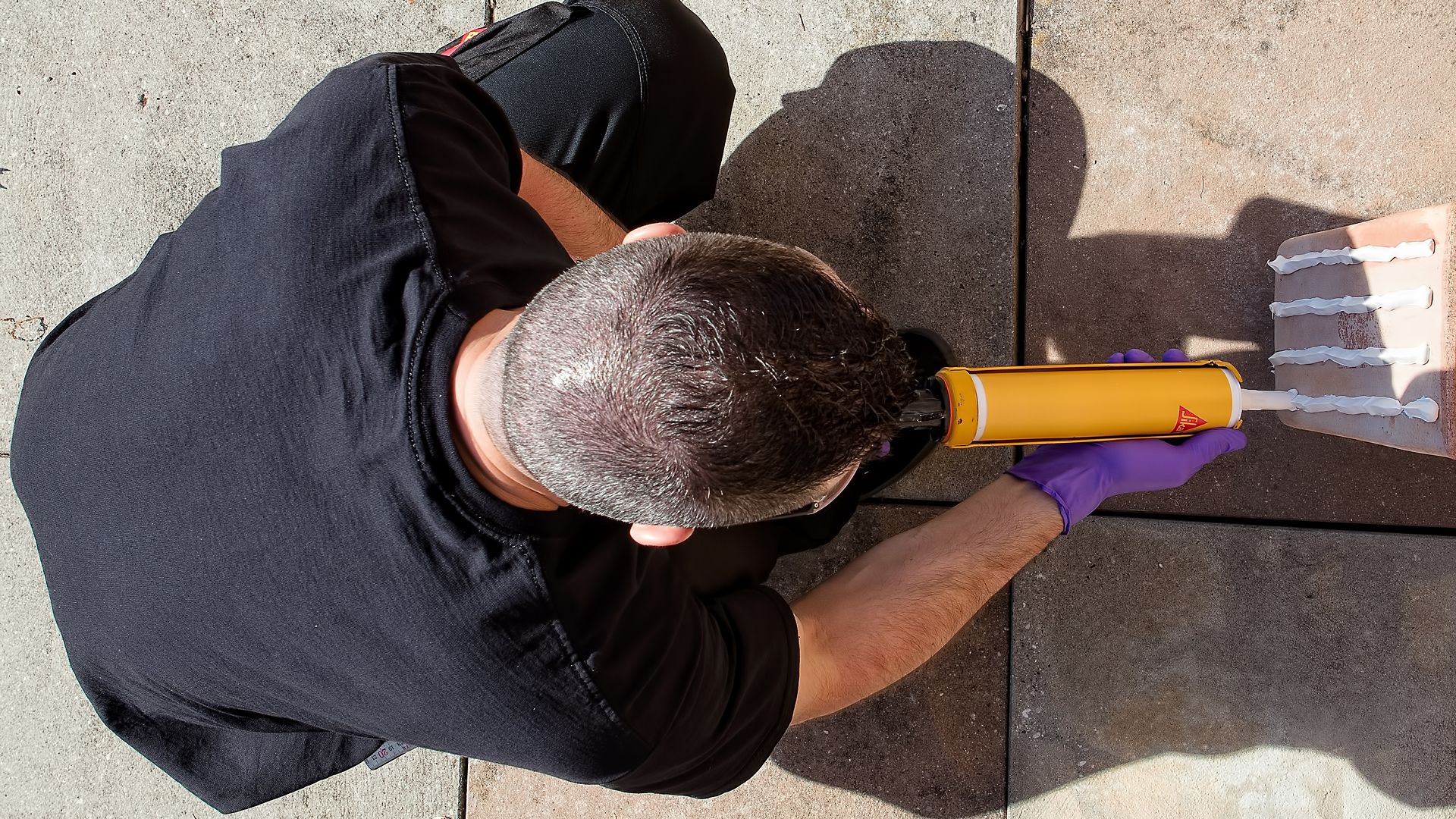 Man Applying Construction Adhesive