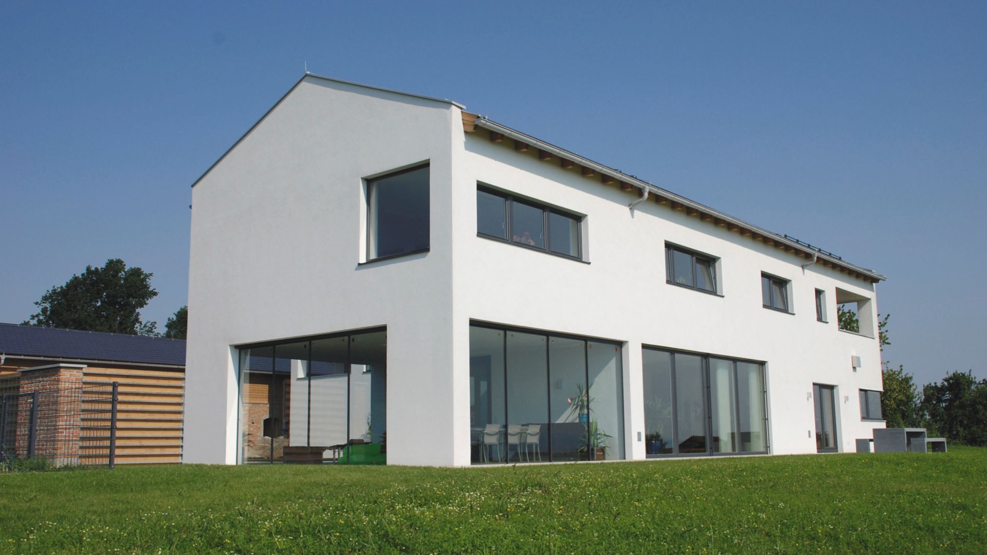 White residential building with green garden